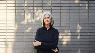Deborah Berke in front of brick wall