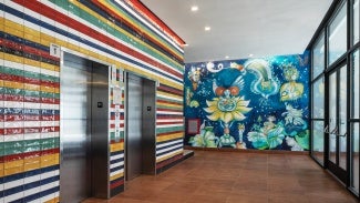 Colored tile on elevator core derived from flags of Latin American countries, mural painted by Aurelio del Muro and Marta Blair