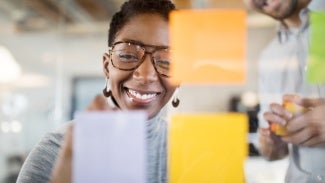 Woman and man collaborating with post it notes