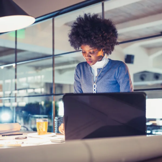 women in an open office working at a desk